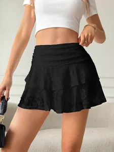 Close-up detail of black lace tiered mini skirt showing layered cake design and texture