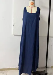 Close-up view of a minimalist loose sleeveless bohemian maxi dress in dark blue cotton fabric