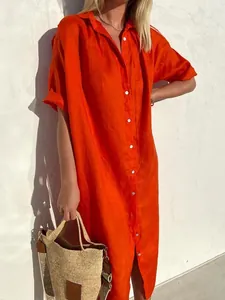 Full view of elegant orange cotton linen maxi shirt dress in natural sunlight