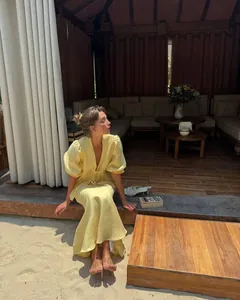 Yellow linen two-piece set featuring puff sleeves and tie-front top for summer beach trips