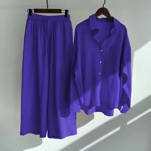Detail view of the purple 2-piece set with linen texture shirt and wide-leg loose pants.