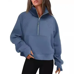 Women's half-zip cropped sweatshirt with stand collar and thumb holes in blue.