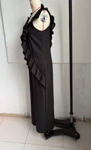 Side view detail of a black sleeveless linen jumpsuit with ruffle V-neck for summer