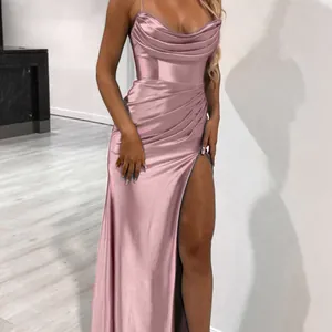 Detailed view of pink satin evening dress featuring draped waist and high leg slit