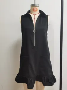 Close-up of black sleeveless A-line dress with half-zip V-neck and ruffled hem detail