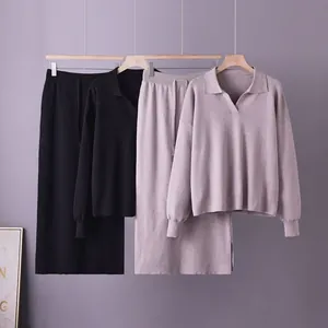 Detail view of the two-piece knitted Polo sweater and skirt set in black and mauve