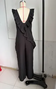 Detailed back view of a black linen sleeveless v-neck jumpsuit featuring elegant ruffle trim