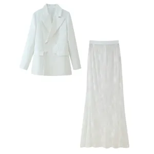 Detail view of a white double-breasted blazer paired with a delicate floral lace maxi skirt