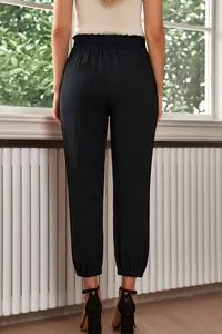 Detailed back view of women's high-waisted black joggers with elastic cuffs and waist.