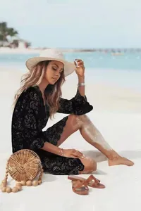 Elegant black lace bikini cover-up featuring a V-neck and delicate floral patterns.