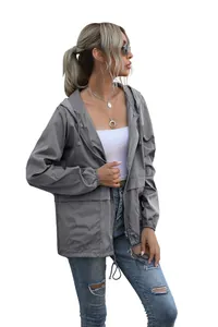 Detailed side profile view of a gray lightweight hooded outdoor windbreaker for women