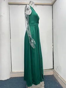 Side view of elegant green sleeveless high-waist maxi dress with a thigh-high slit