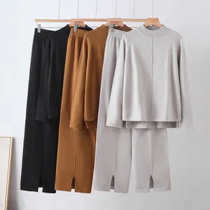 Detail display of women's oversized knit sweater and slit wide-leg pants set in three colors