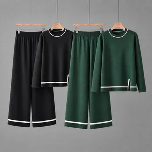 Detailed view of women's long-sleeve knit sets in black and forest green with contrast trim