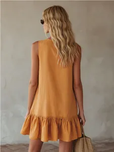 Back view of a mustard yellow sleeveless summer dress with elegant ruffled hem details