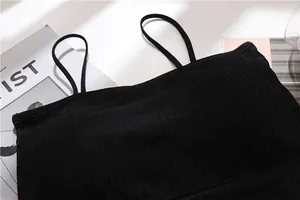 Detailed macro view of black seamless ribbed bandeau bra featuring thin spaghetti straps