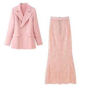 Detail view of pink double-breasted blazer and floral lace maxi skirt set.