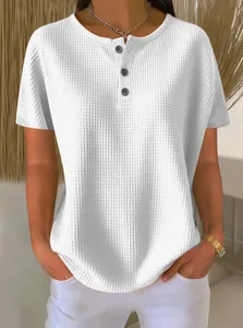 Detailed view of women's white waffle knit top showing texture and henley button neckline.