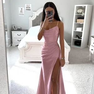 Mirror selfie showing the full-length pink satin dress with ruching and high slit