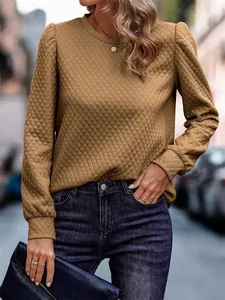 Close-up view of the quilted texture and bubble sleeve detail on the camel sweatshirt