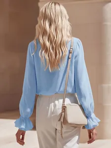 Back view of a light blue linen shirt featuring elegant ruffled cuffs and romantic texture.