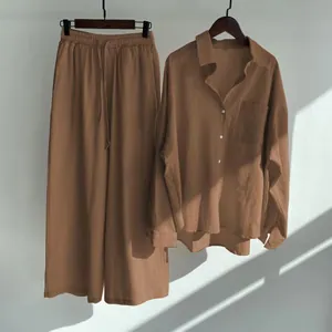 Detailed texture of women's cotton linen two-piece set shirt and pants in warm light