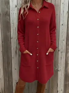 Detailed view of the red knit button-down polo dress with functional side pockets.