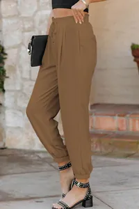 Detailed side view of women's brown high-waisted drawstring jogger pants in a casual style