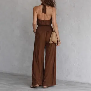 Back view of a bohemian brown backless wide-leg jumpsuit with gathered waist detail