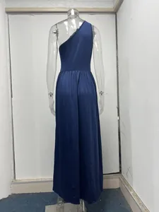 Detailed back view of a navy blue one-shoulder high-waist maxi dress on a clear mannequin