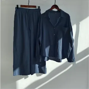 Detail view of women's vintage cotton linen shirt and wide-leg trousers set