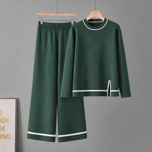 Women's dark green knit two-piece set with side slit top and wide-leg striped pants