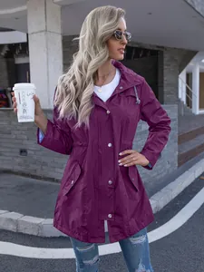 Detail of purple hooded long raincoat jacket with drawstring waist and metal buttons