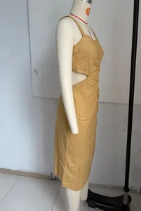 Dettaglio di un abito midi giallo senape con ritaglio laterale e arricciatura
