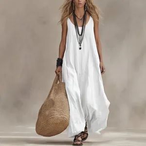 Bohemian sleeveless loose vacation maxi dress in white with a textured background.