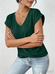Detail of elegant dark green V-neck T-shirt with twisted hem and rolled sleeves.