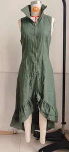 Front view of green sleeveless dress with high collar and ruffle hem details