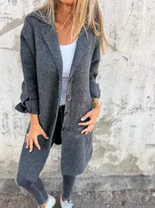 Detail view showing texture of dark grey mid-length cardigan coat with lapel and buttons