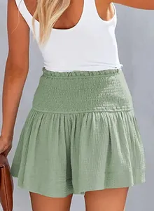 Detailed view of women's green high-waisted smocked cotton linen skorts with ruffles
