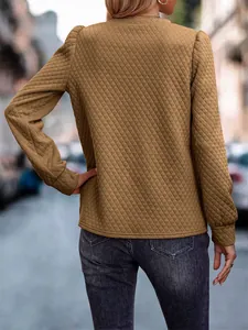 Rear view of brown quilted sweatshirt featuring puff sleeves and diamond pattern texture