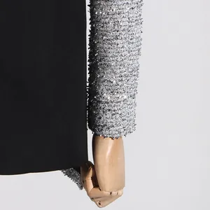 Close-up of black blazer featuring textured silver metallic tweed sleeve detail.
