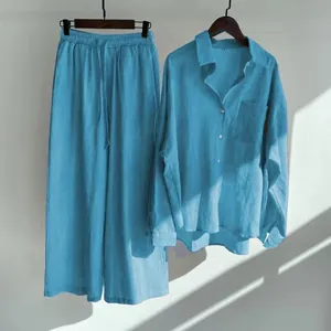 Detailed view of women's two-piece blue cotton linen shirt and wide-leg trousers
