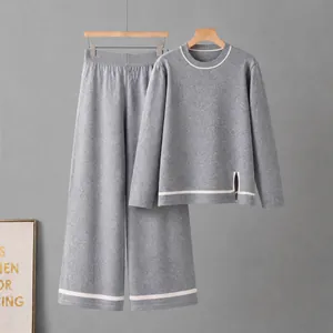 Macro detail of grey knitted two-piece set with contrast stripes and side slit