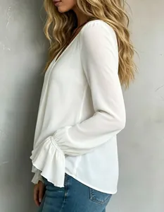 Detail view of an elegant white V-neck blouse featuring stylish ruffled cuffs.
