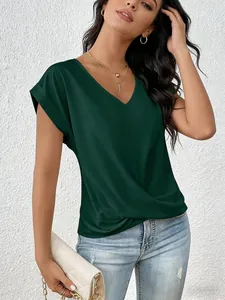 Detail view of an elegant dark green V-neck T-shirt with a stylish twist hem detail.