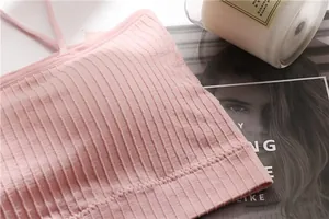 Macro detail showing the soft pink ribbed texture of a seamless tube top bralette fabric