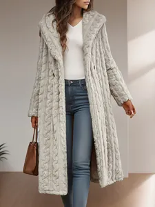 Detail showing the textured plush fabric of the long hooded winter coat for women.