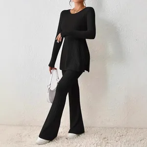 Elegant women's black solid color ribbed knit two-piece set with slim fit flared pants