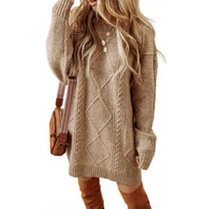 Close-up detail of oversized cable knit sweater dress featuring classic diamond patterns