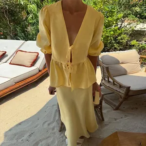 Elegant summer yellow linen two-piece set with puff sleeve V-neck top and midi skirt